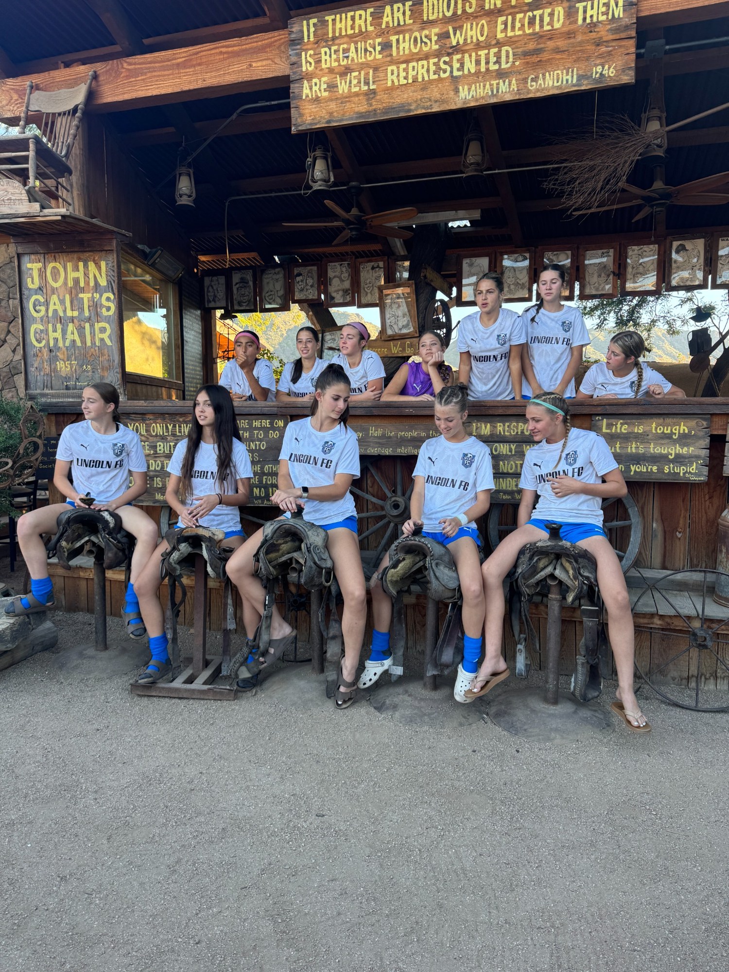The team gathered outside a restaurant